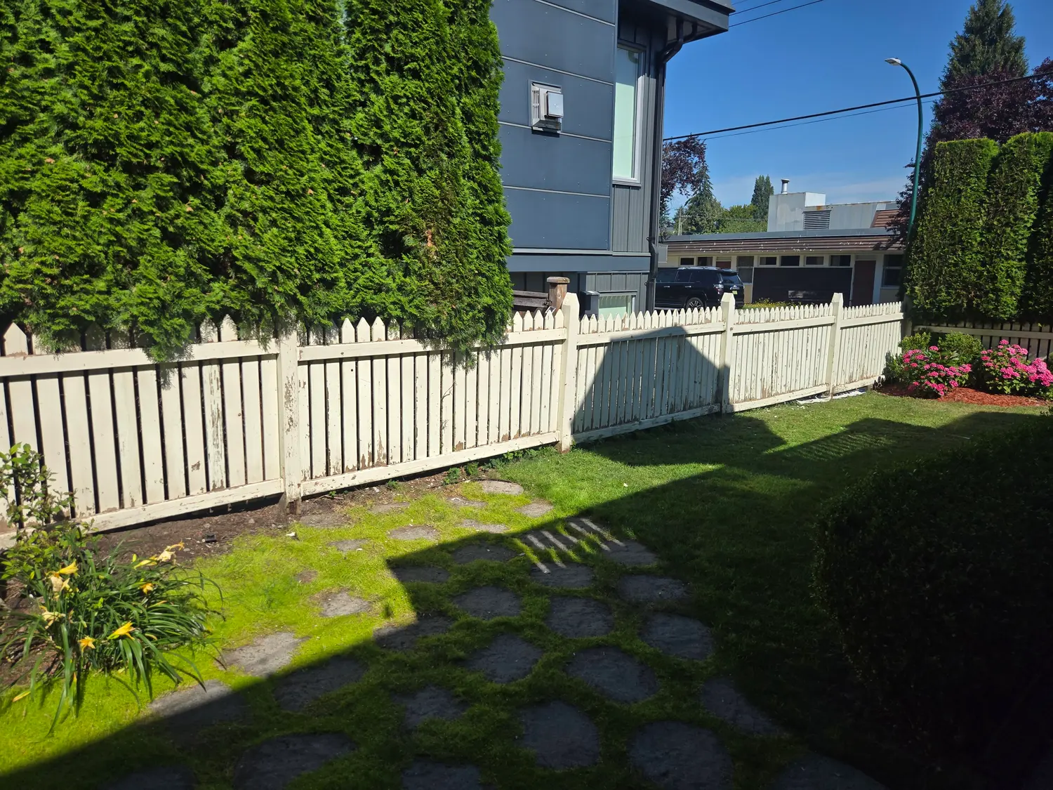 Old picket fence with paint peeling down to bare grey wood