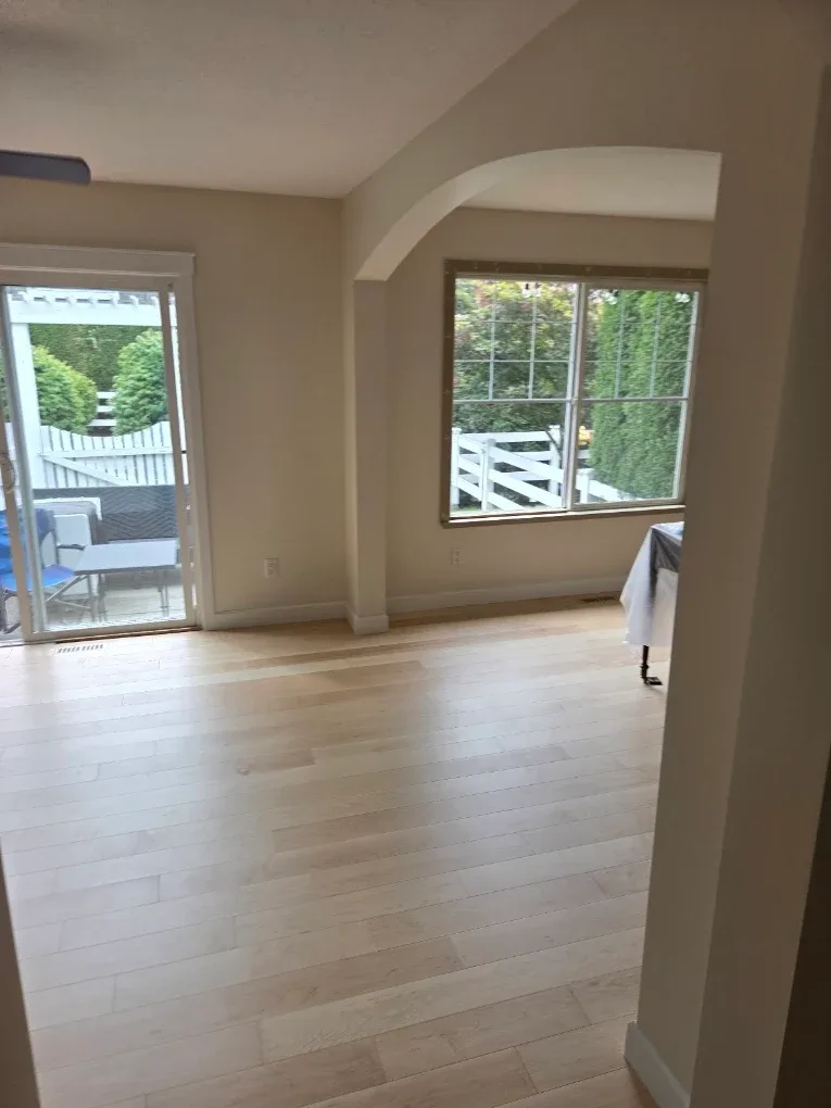 Open living space with an archway, repainted in a warm neutral