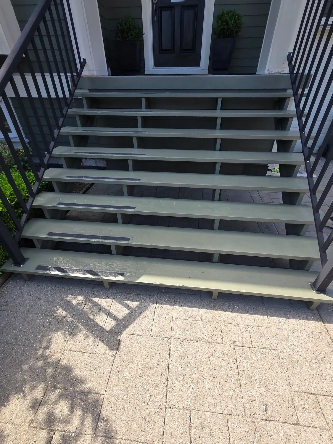 The same front steps refinished in a clean sage green